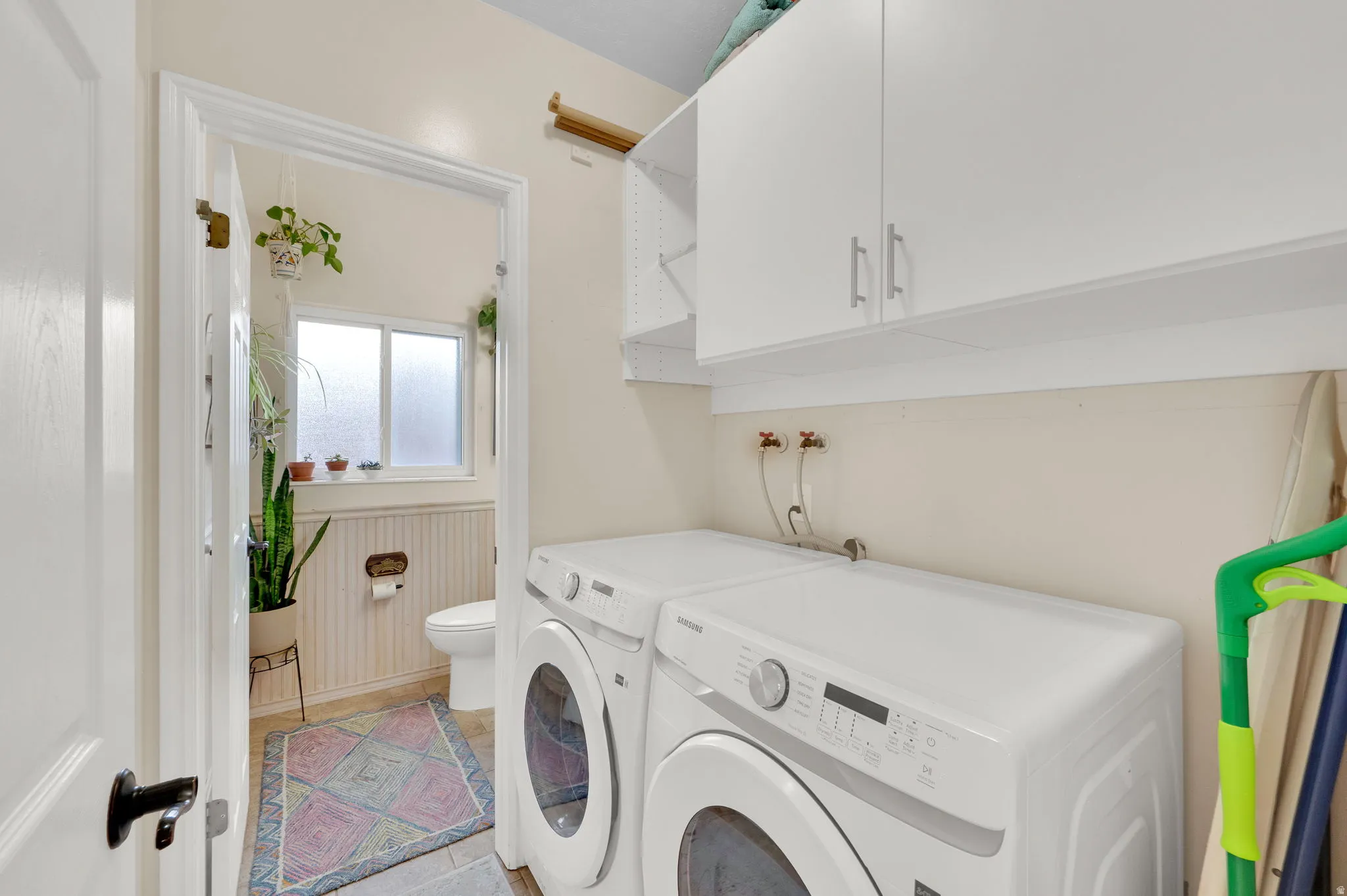 Dedicated laundry area featuring a white front-loading washer and dryer set
