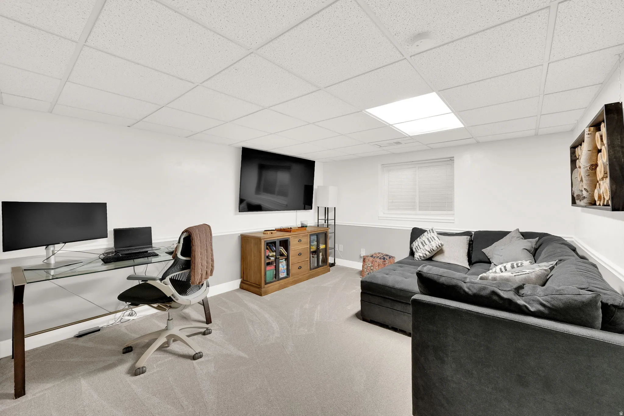Finished lower level featuring recessed lighting, a drop ceiling, and light gray carpeting