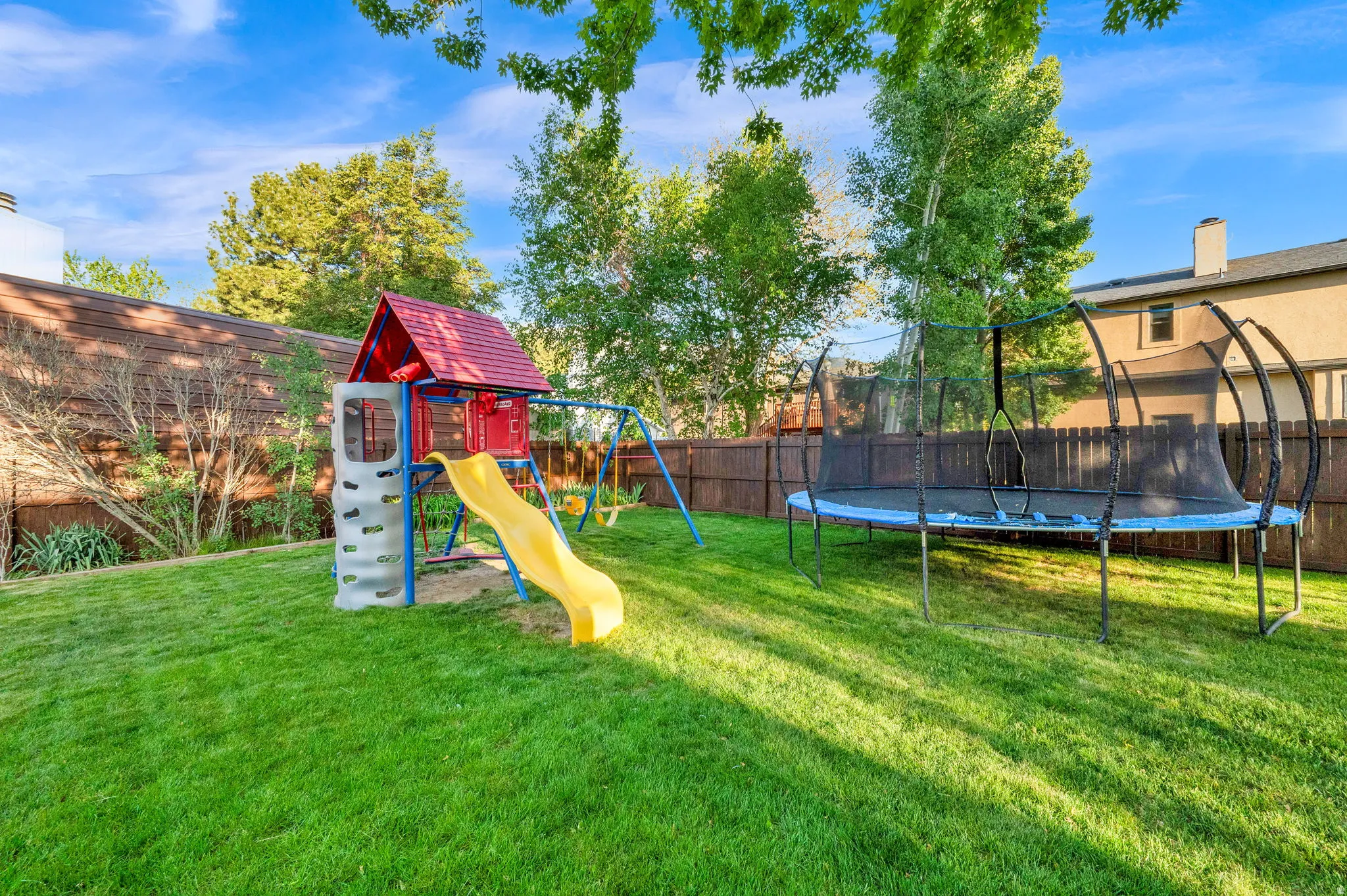 Expansive backyard featuring a lush lawn and perimeter fencing