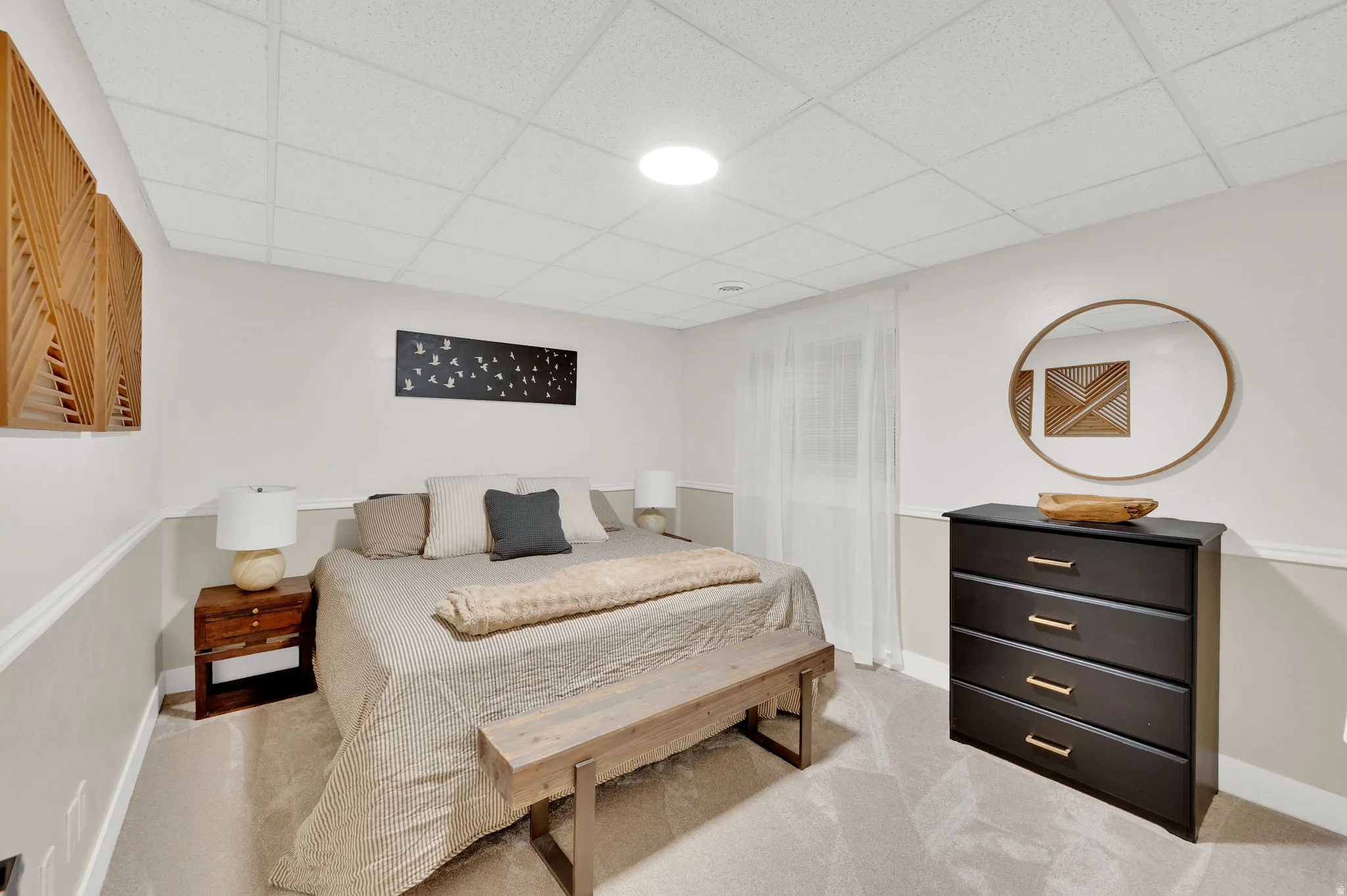 Bedroom featuring neutral-toned carpet flooring and a drop ceiling with recessed lighting