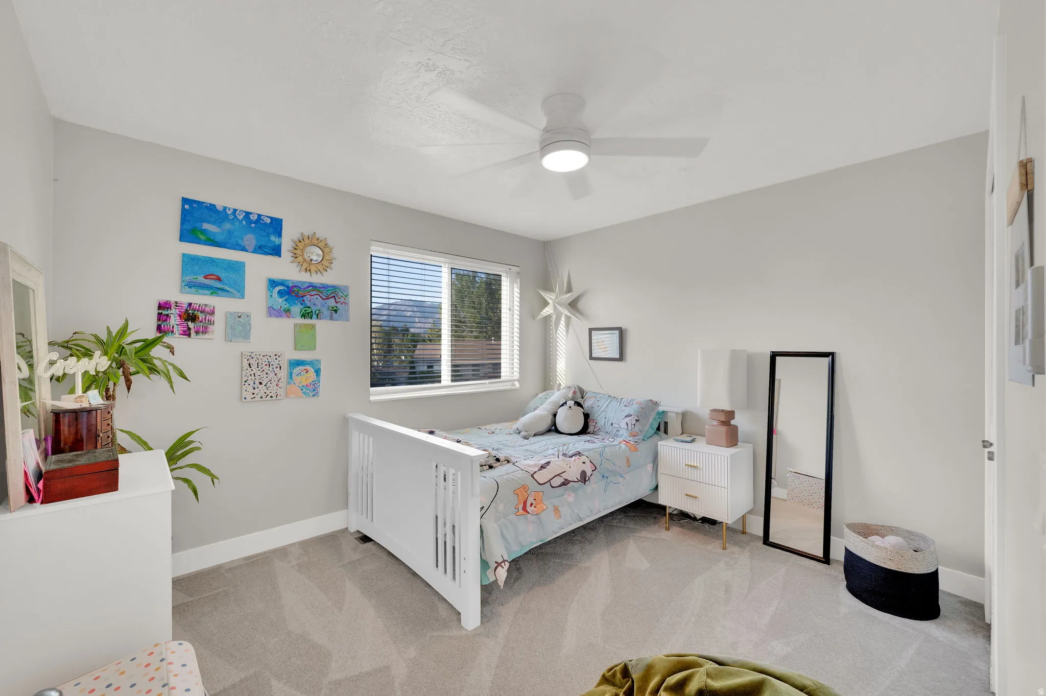 Room featuring soft grey walls and light-toned carpeting