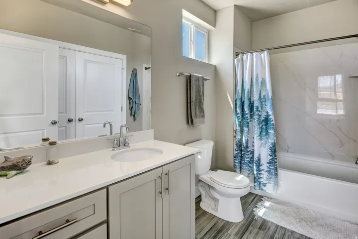 Bathroom featuring a vanity with an integrated sink, light-toned countertop, and light gray cabinetry