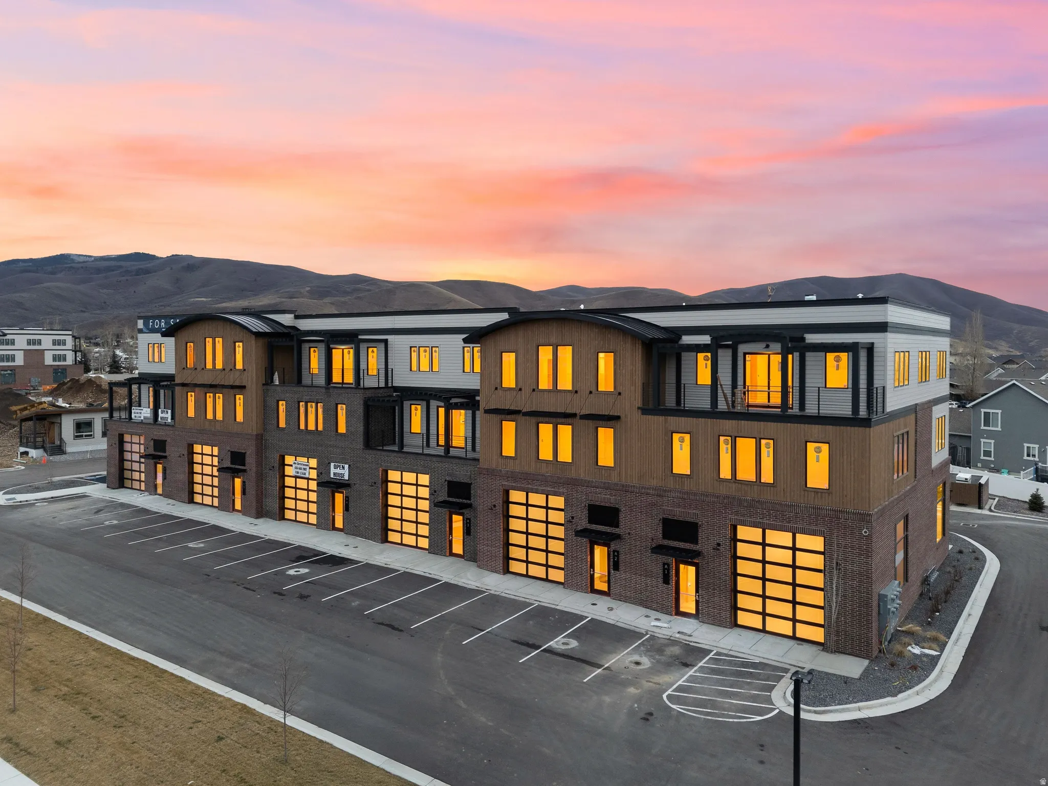 Modern multi-story building featuring brick and wood-paneling exterior finishes