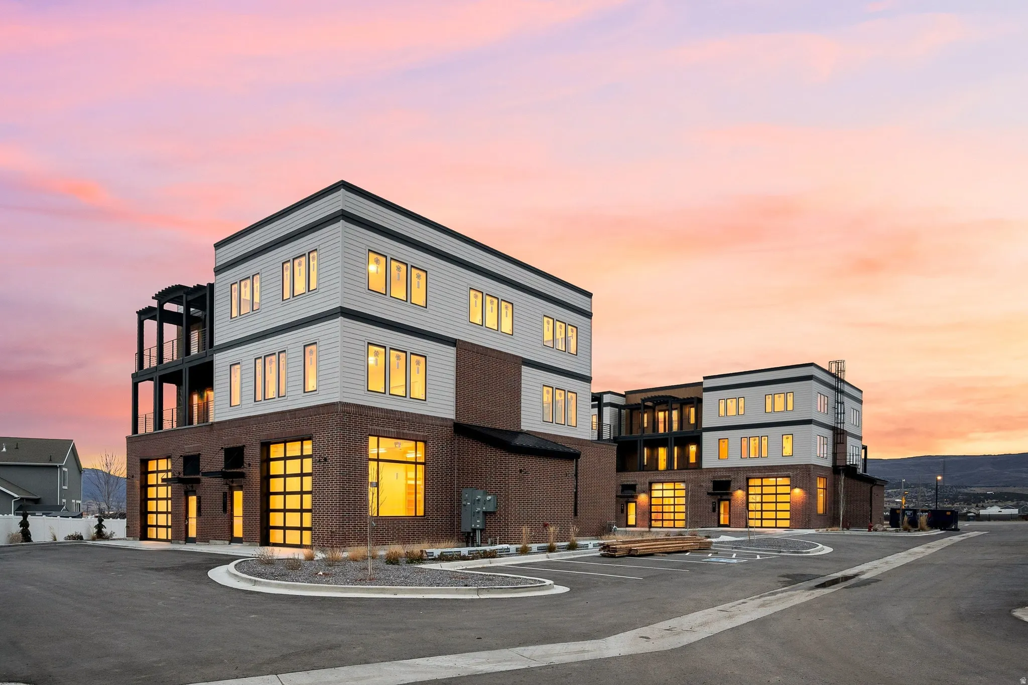 Modern multi-level building featuring a brick and horizontal siding exterior