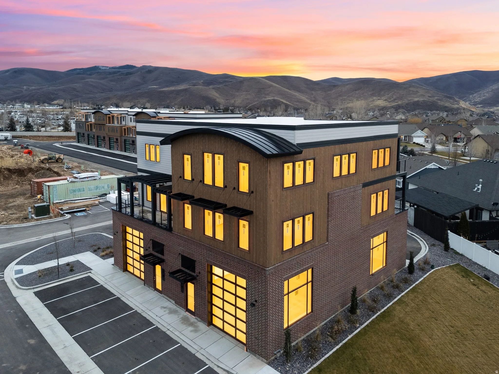 Multi-story commercial building featuring contemporary architecture with a curved metal roof accent