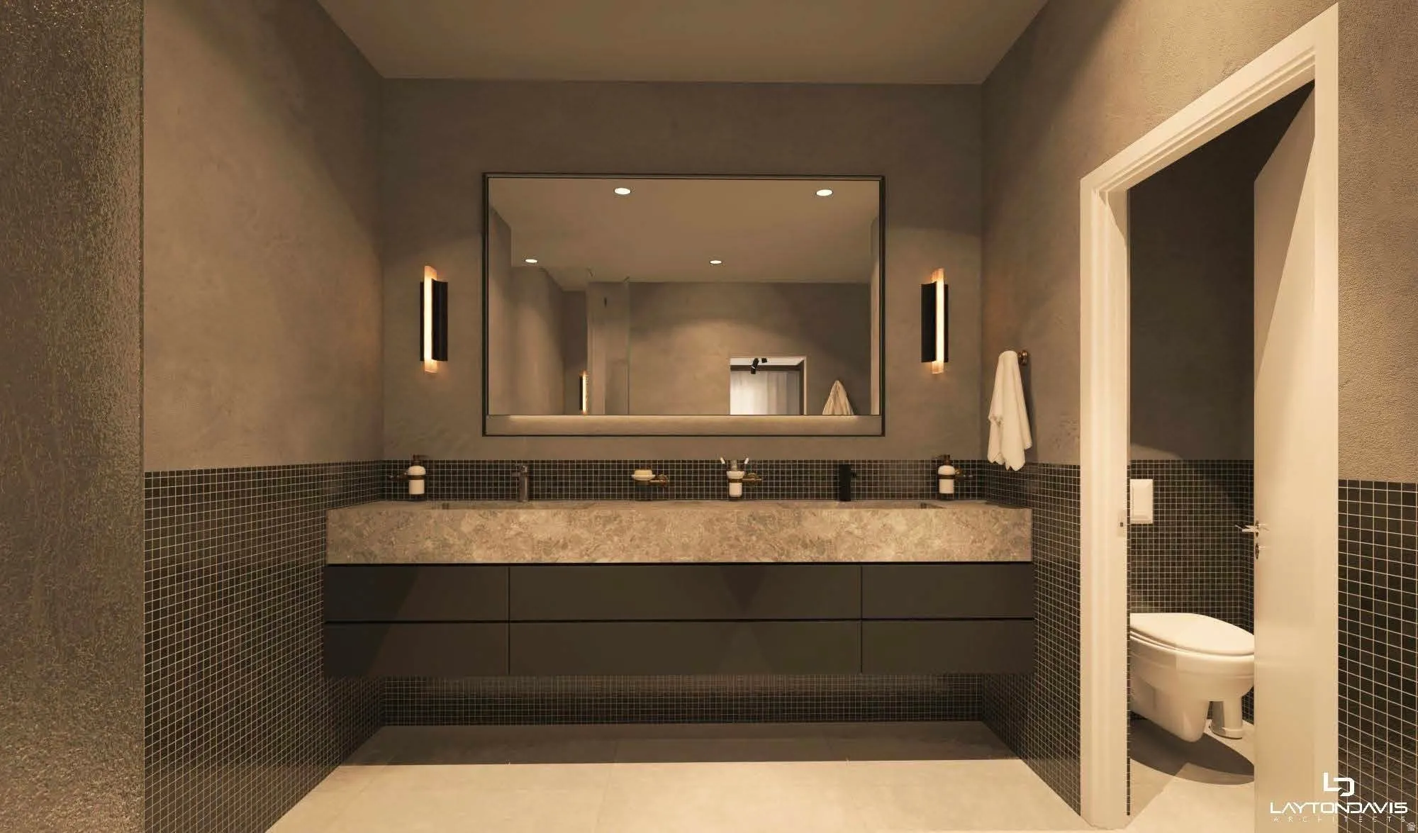 Dual vessel sinks set into a stone vanity countertop with dark flat-panel cabinetry