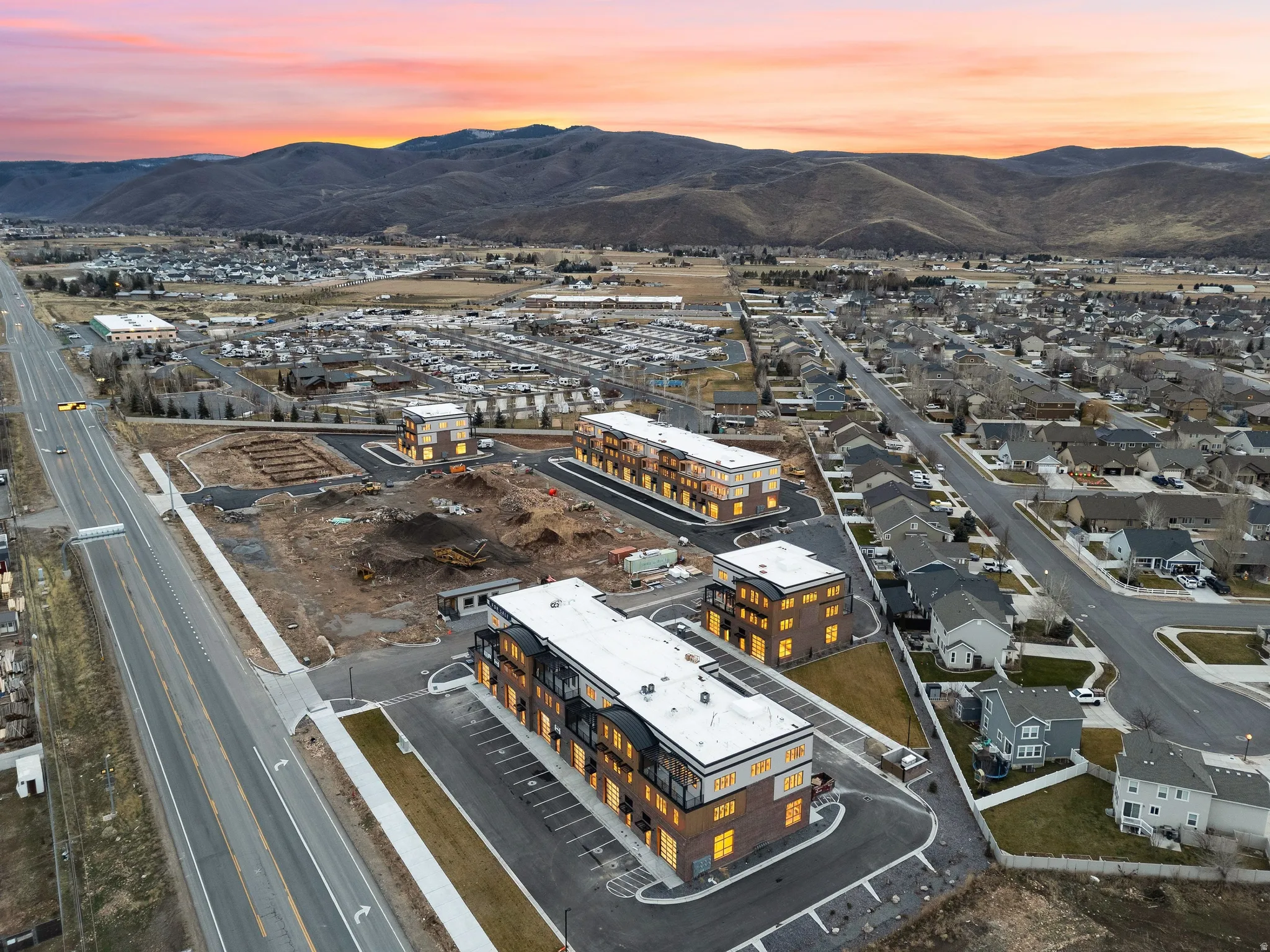 Aerial perspective of contemporary multi-story buildings featuring brick and dark-paneled facades