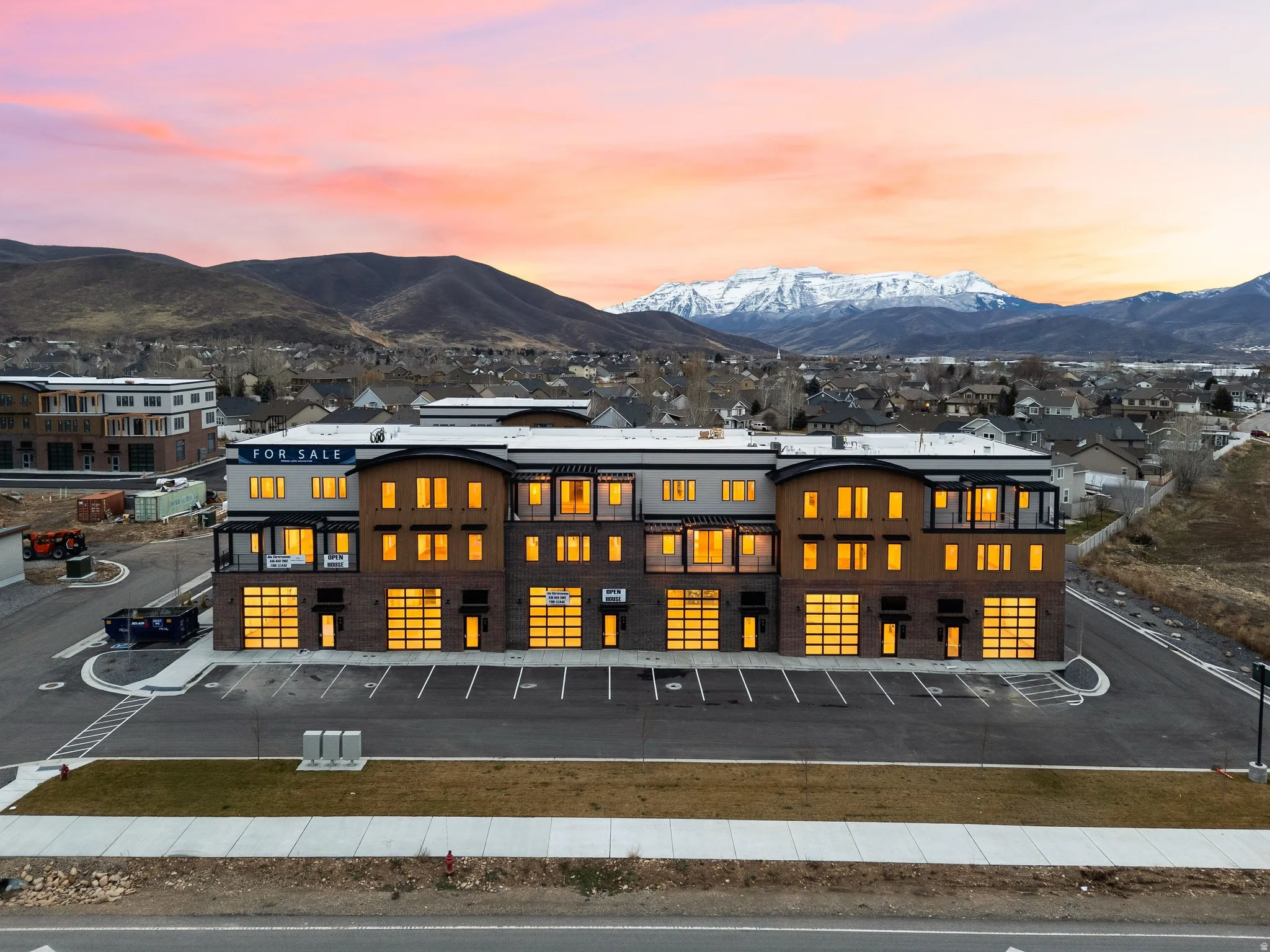 Modern mixed-use building featuring contemporary architectural design with brick and horizontal siding accents