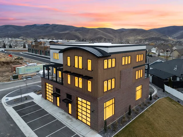 Multi-story commercial building featuring contemporary architecture with a curved metal roof accent
