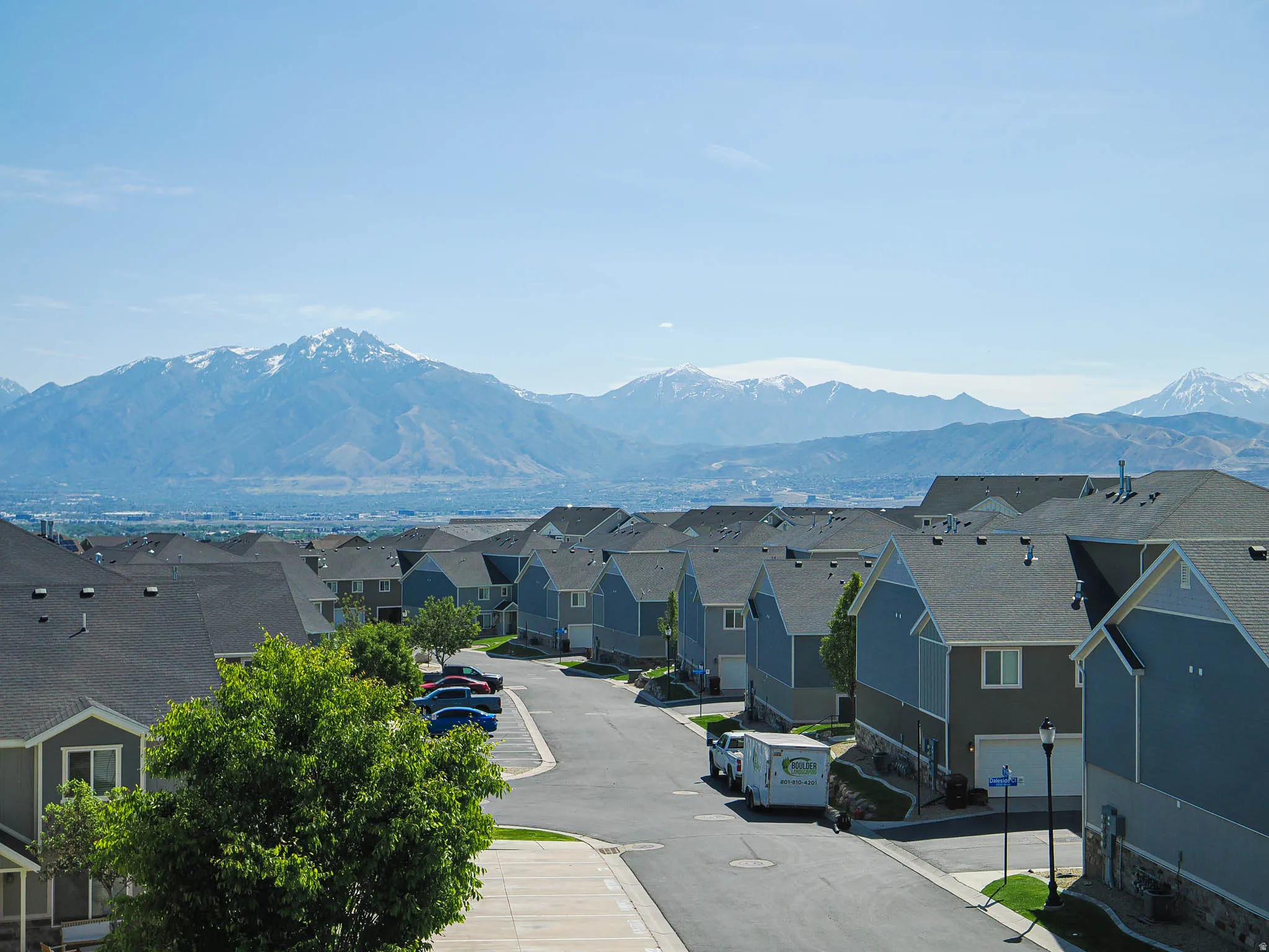 Neighborhood setting with distant snow-capped mountains and a clear sky
