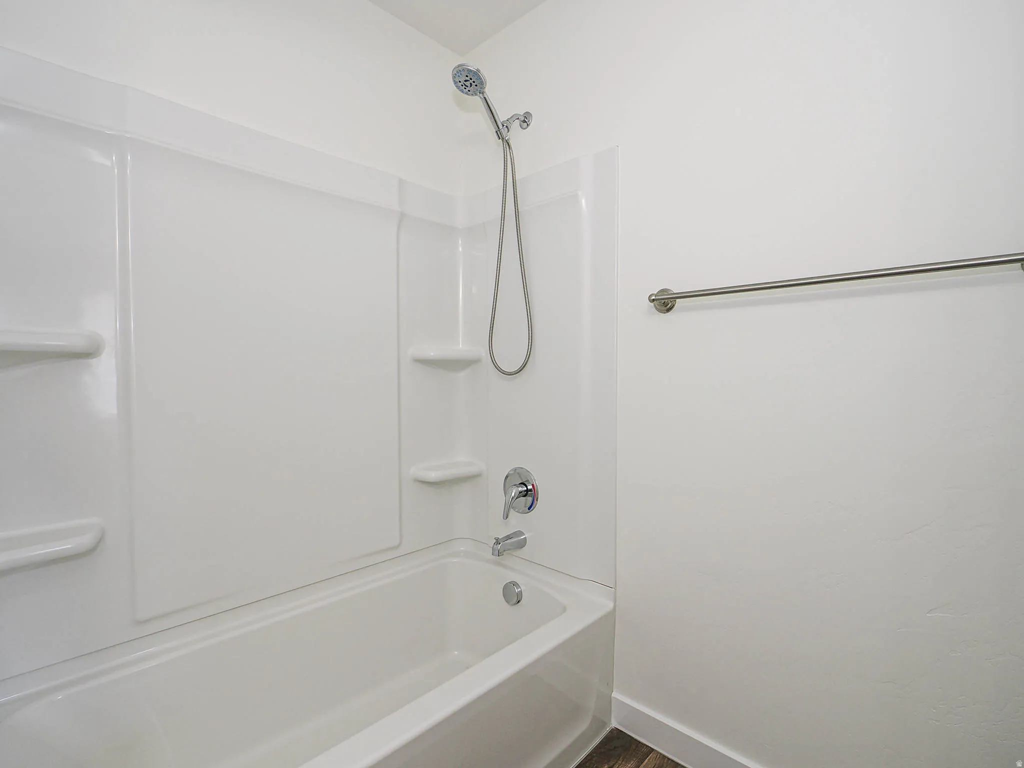Bathtub with integrated shower system and white surround
