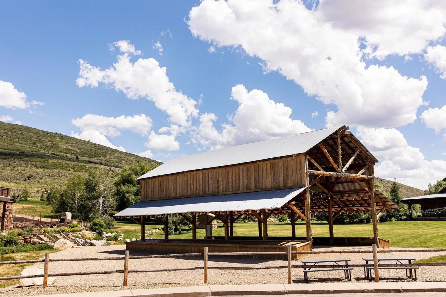 Spacious open-air pavilion featuring exposed timber framing and a metal roof
