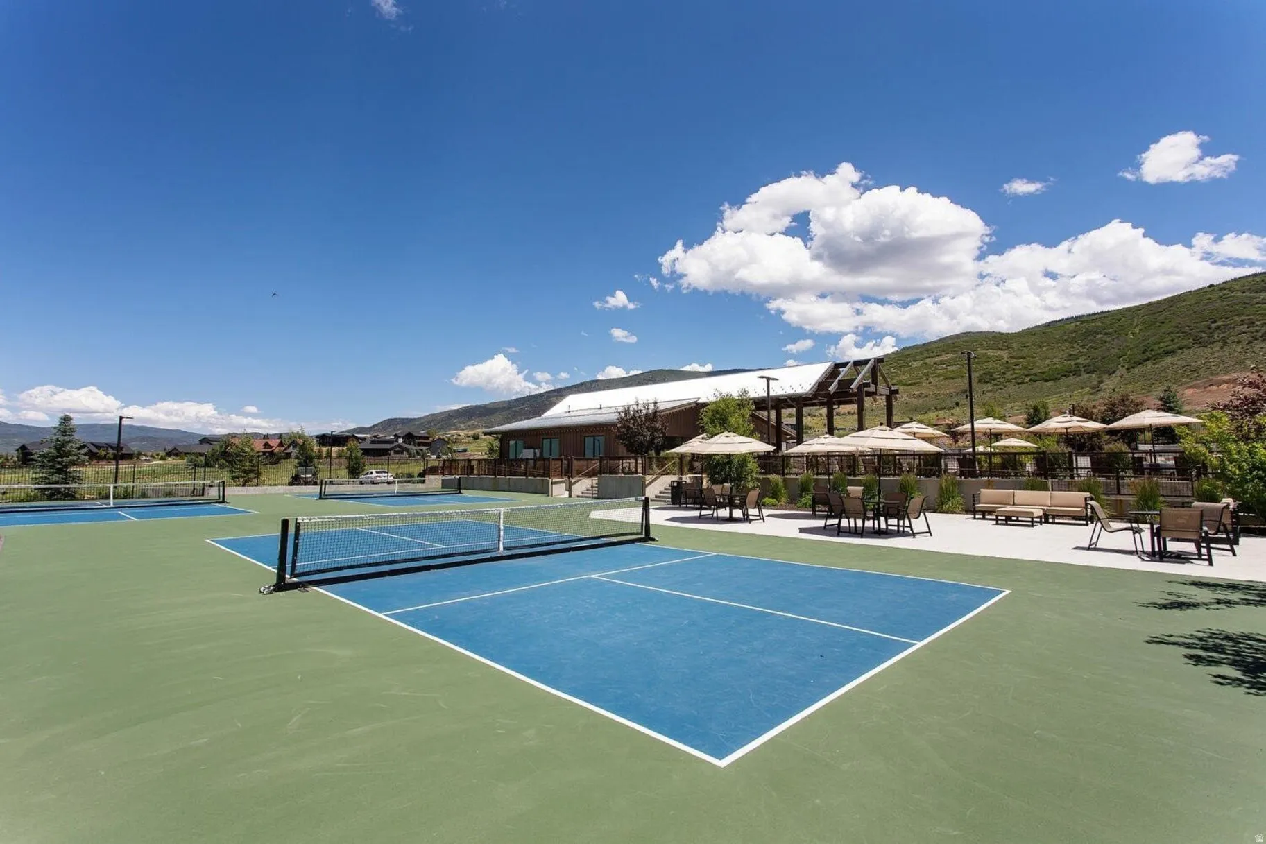 Multiple outdoor courts with blue and green surfacing