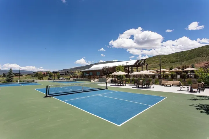 Multiple outdoor courts with blue and green surfacing