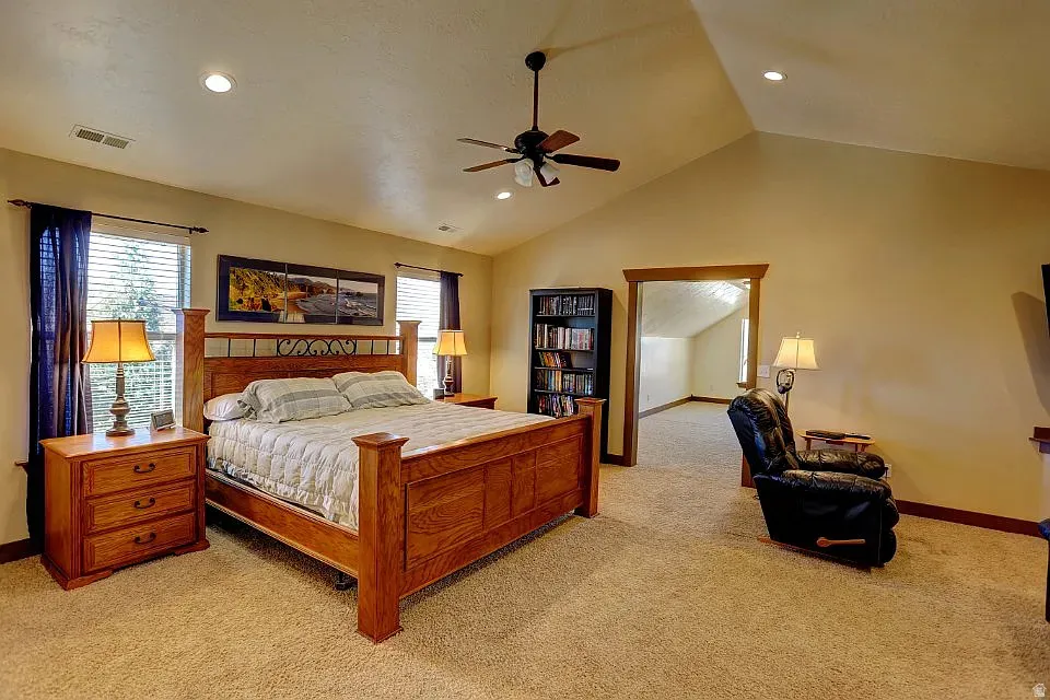 Vaulted ceiling bedroom featuring recessed lighting and a ceiling fan