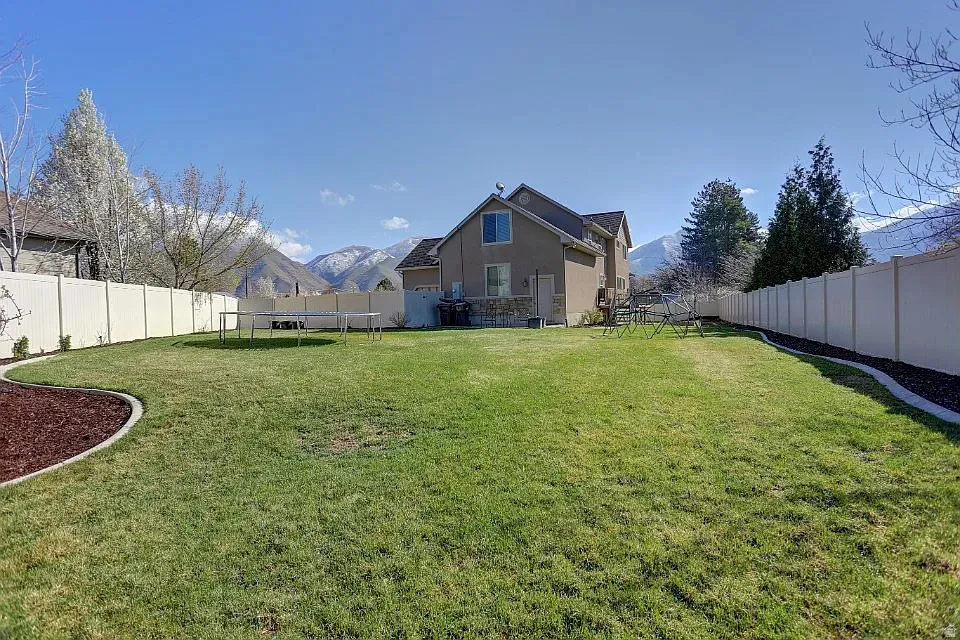 Expansive green lawn with a perimeter fence