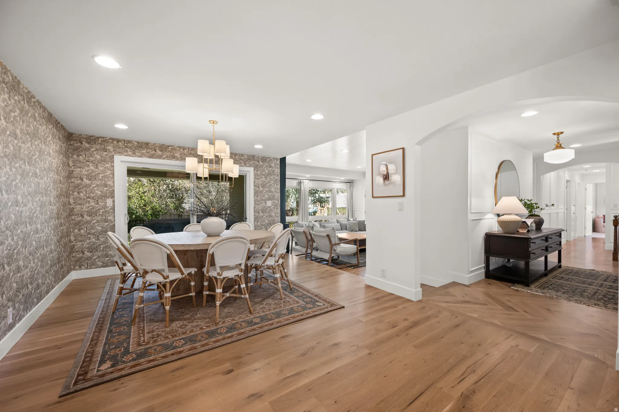 Dining area featuring a contemporary chandelier, recessed lighting, and a large window