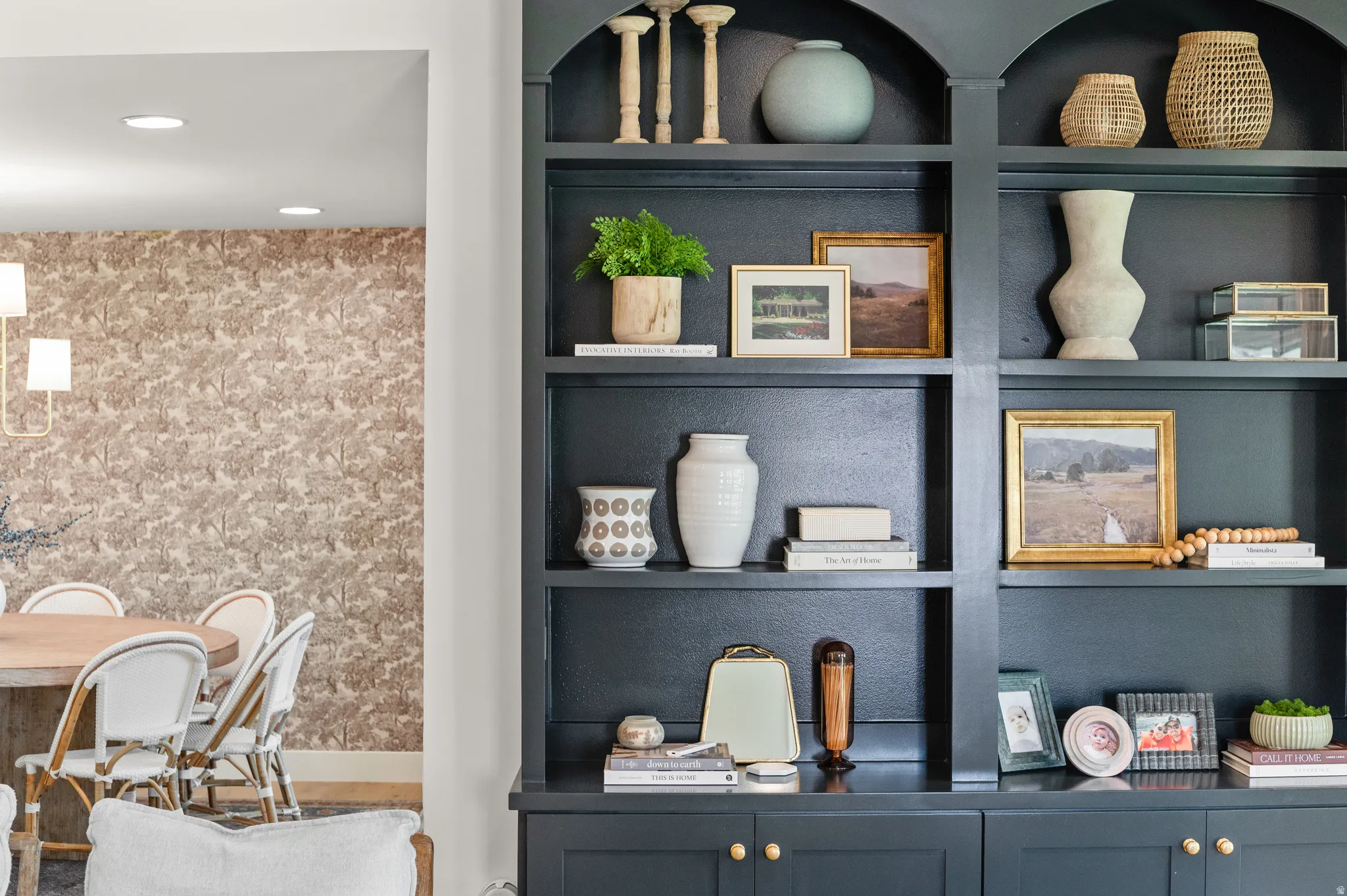 Built-in shelving unit featuring a dark finish and arched upper compartments