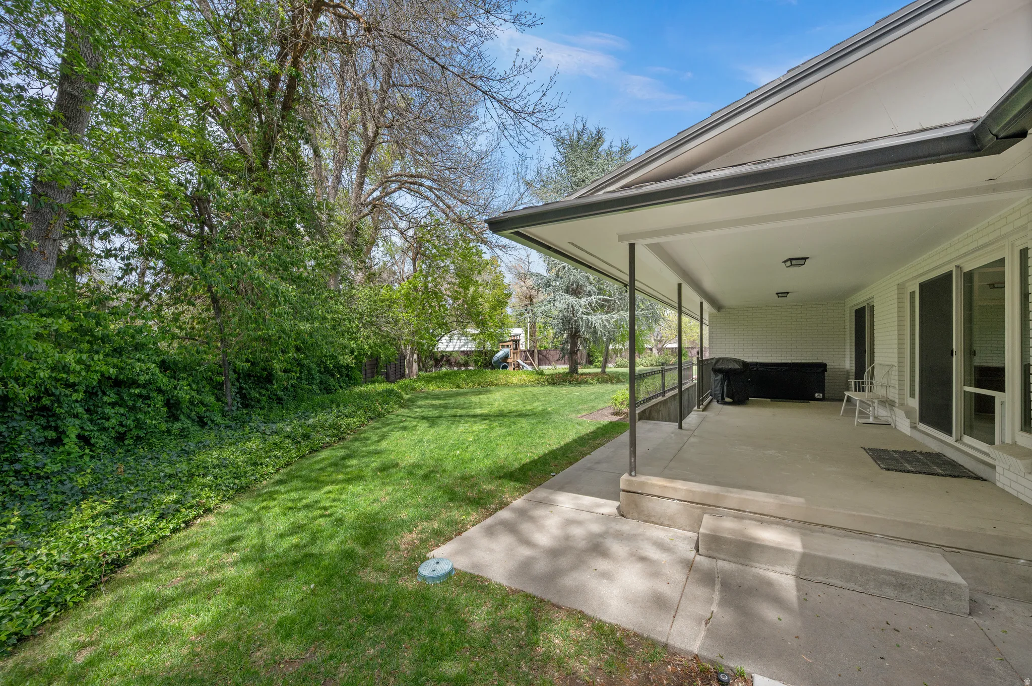 Spacious covered patio with concrete flooring
