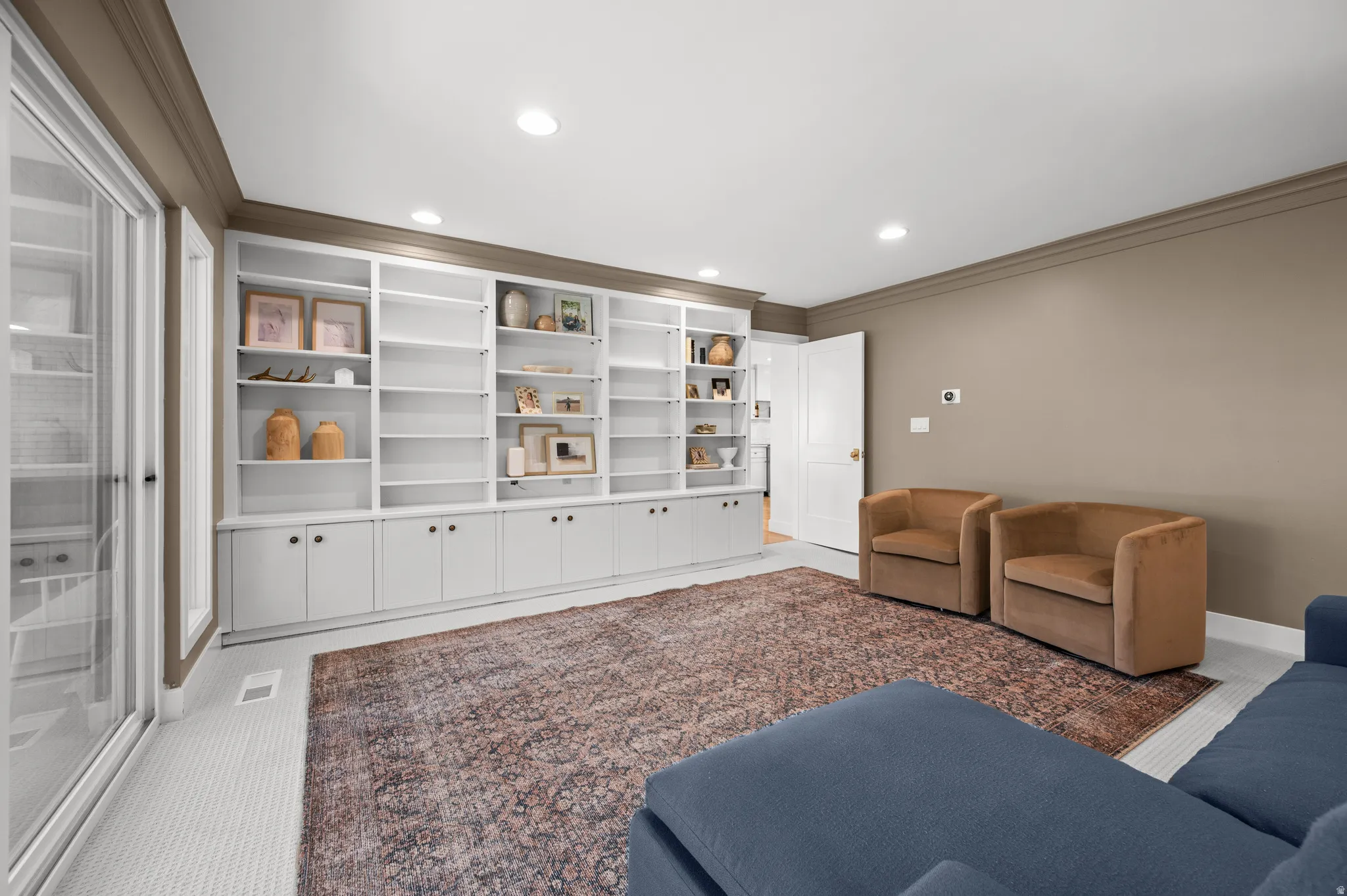 Built-in shelving with lower cabinetry and dark hardware