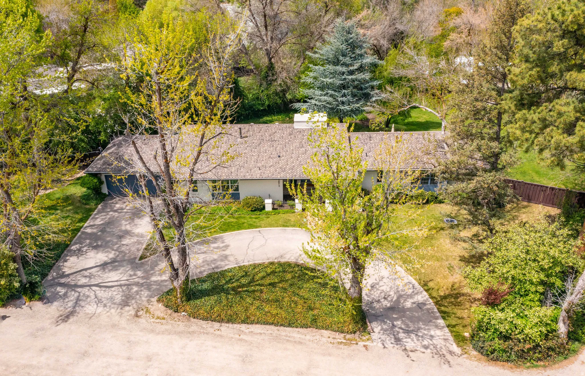 Ranch-style exterior with a shingle roof and a two-car garage