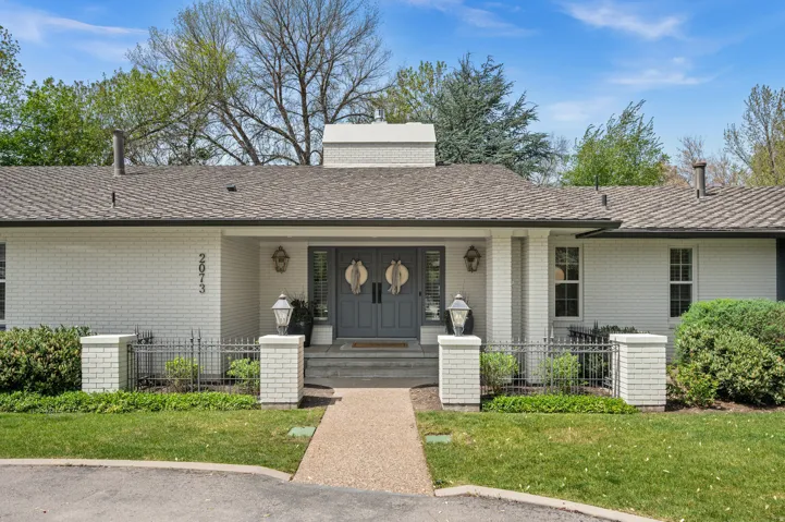 Painted brick exterior with a prominent double door entry