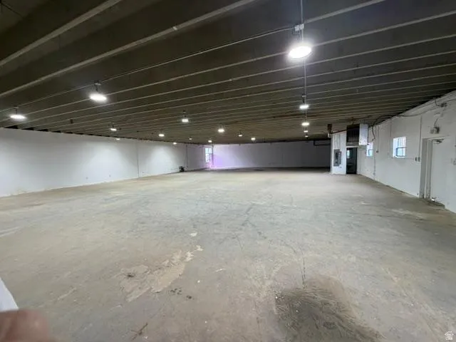 Spacious concrete floor area with exposed beam ceiling