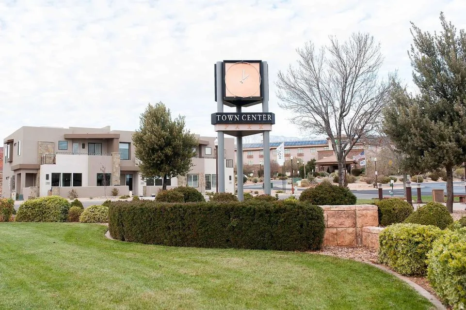 Contemporary multi-story exterior with varying earth tone stucco finishes and stone accents