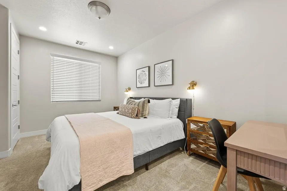 Bedroom featuring light neutral walls, recessed lighting, and a flush-mount ceiling fixture