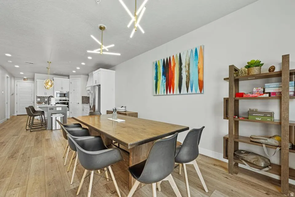 Open-concept living space featuring wood-finish flooring, recessed lighting, and a modern kitchen