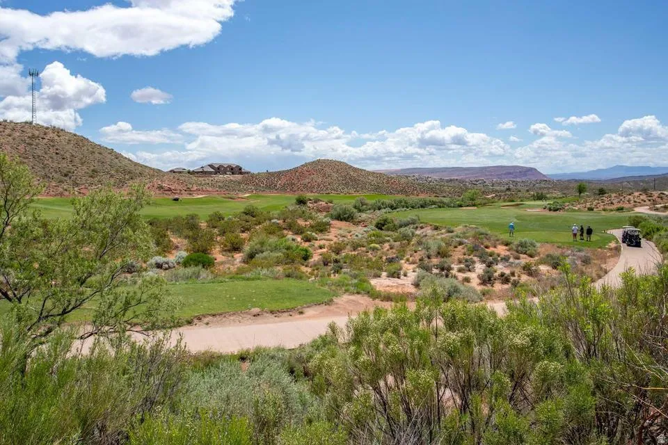Expansive golf course landscape featuring green fairways and natural desert brush
