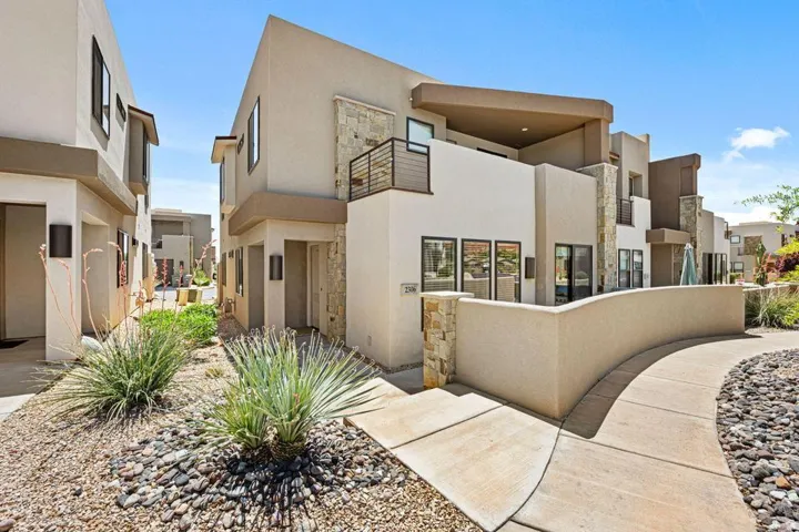 Contemporary stucco exterior with stone accents and a private balcony
