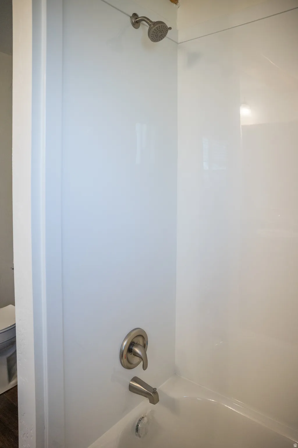 Bathtub shower combination with brushed nickel fixtures