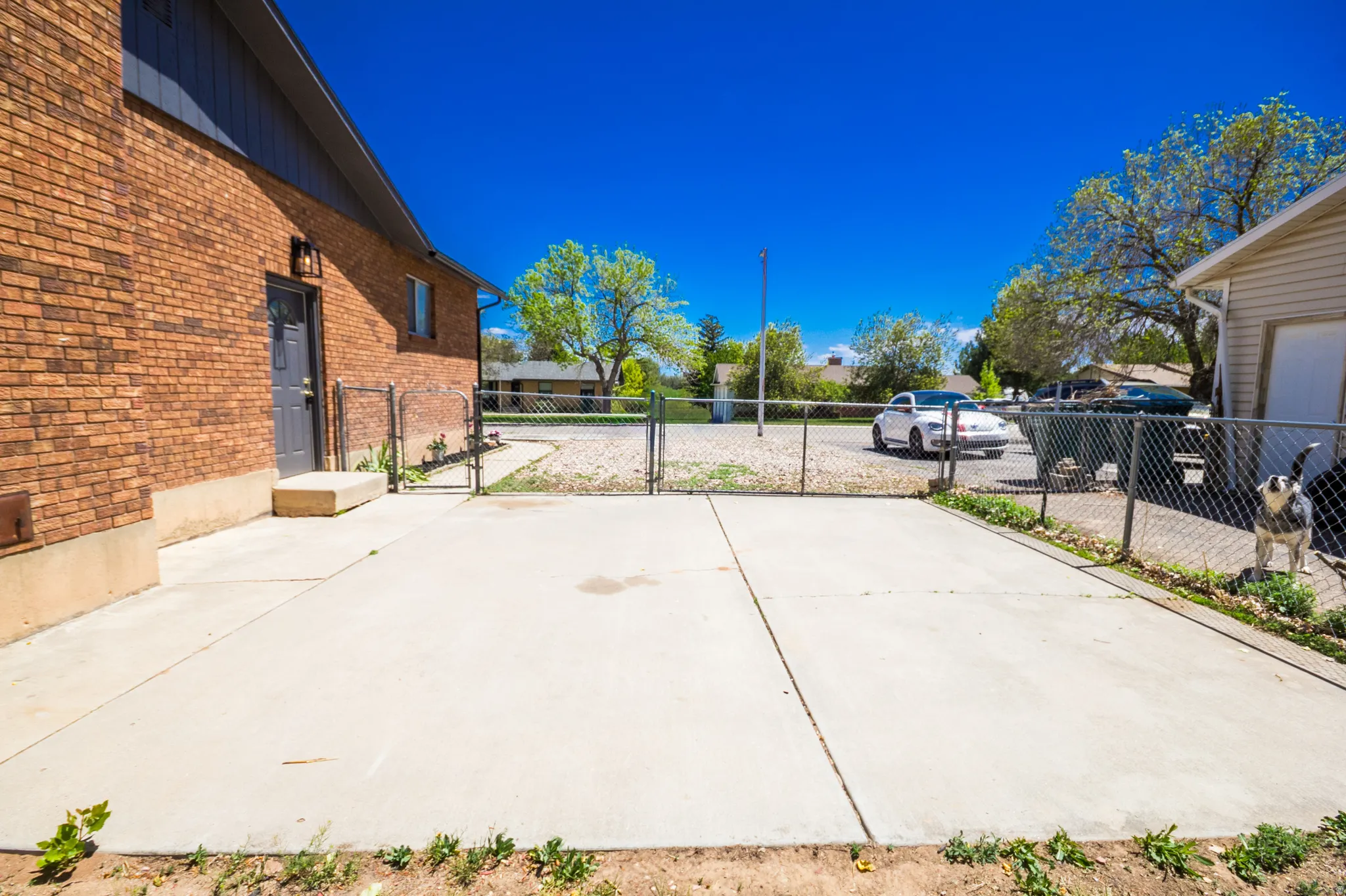 Expansive concrete patio area with chain-link fencing