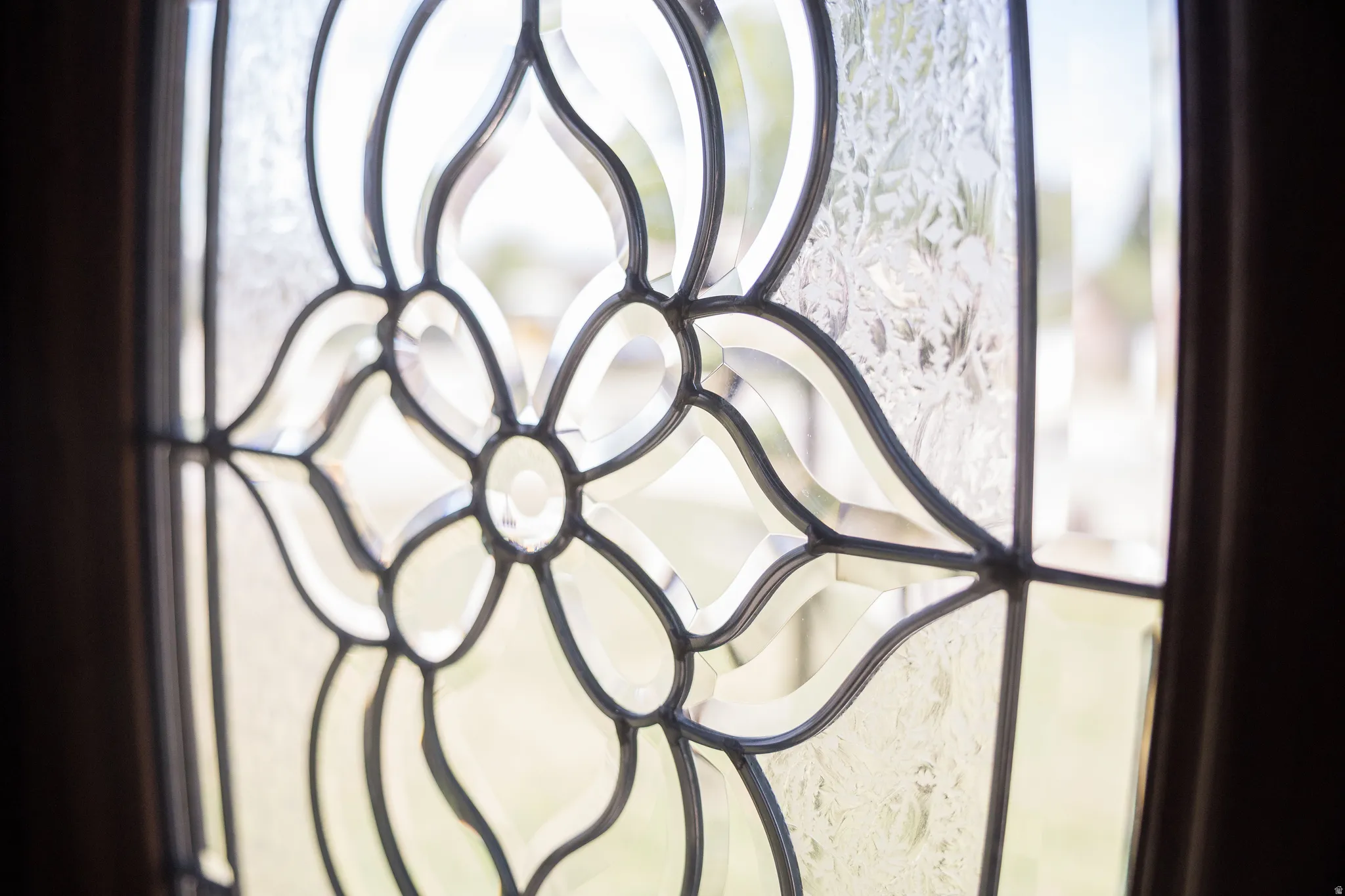 Leaded glass entry detail featuring clear beveled glass and textured glass panels