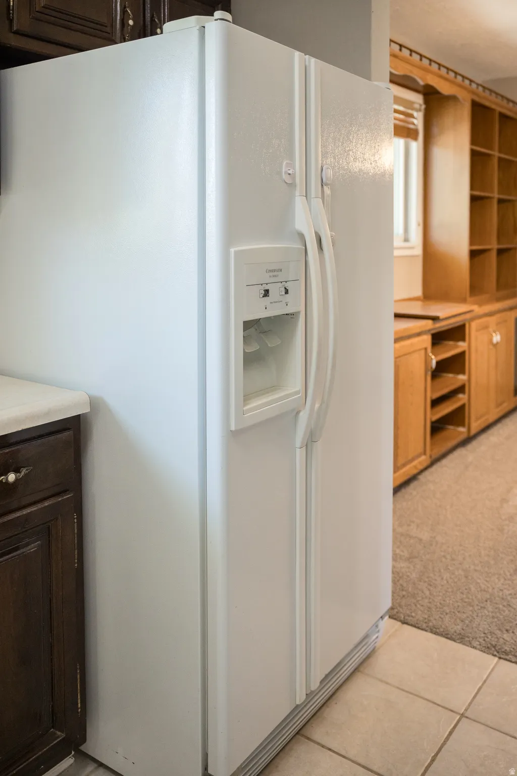 White side-by-side refrigerator with integrated ice and water dispenser