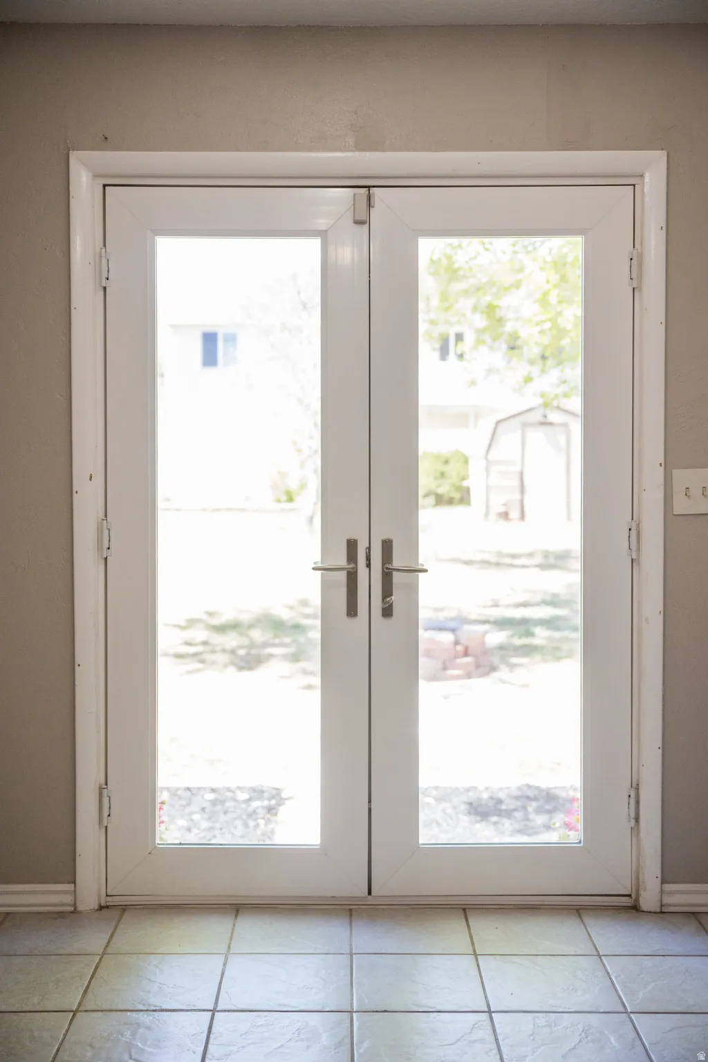 Double French doors with full glass panels and white trim