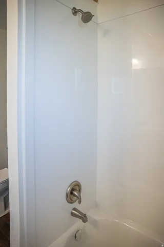 Bathtub shower combination with brushed nickel fixtures