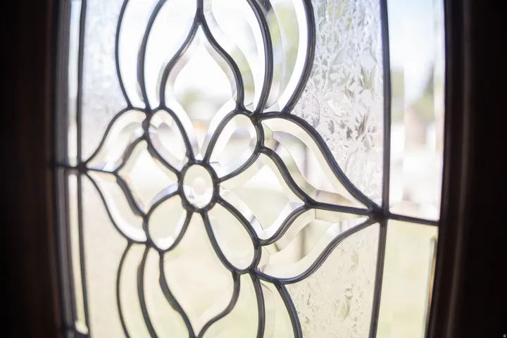 Leaded glass entry detail featuring clear beveled glass and textured glass panels