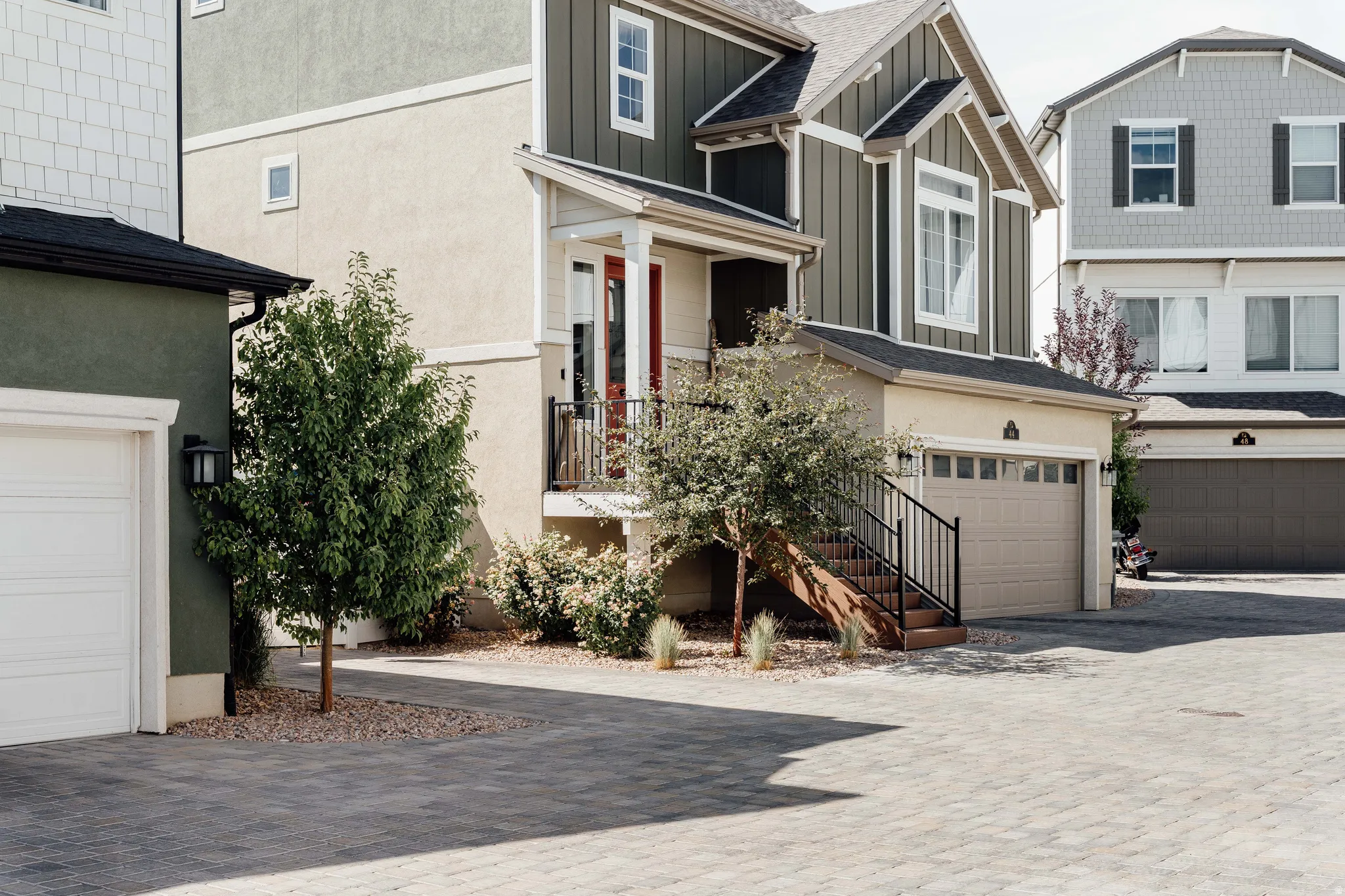 Modern stucco and vertical siding exterior with a covered entry