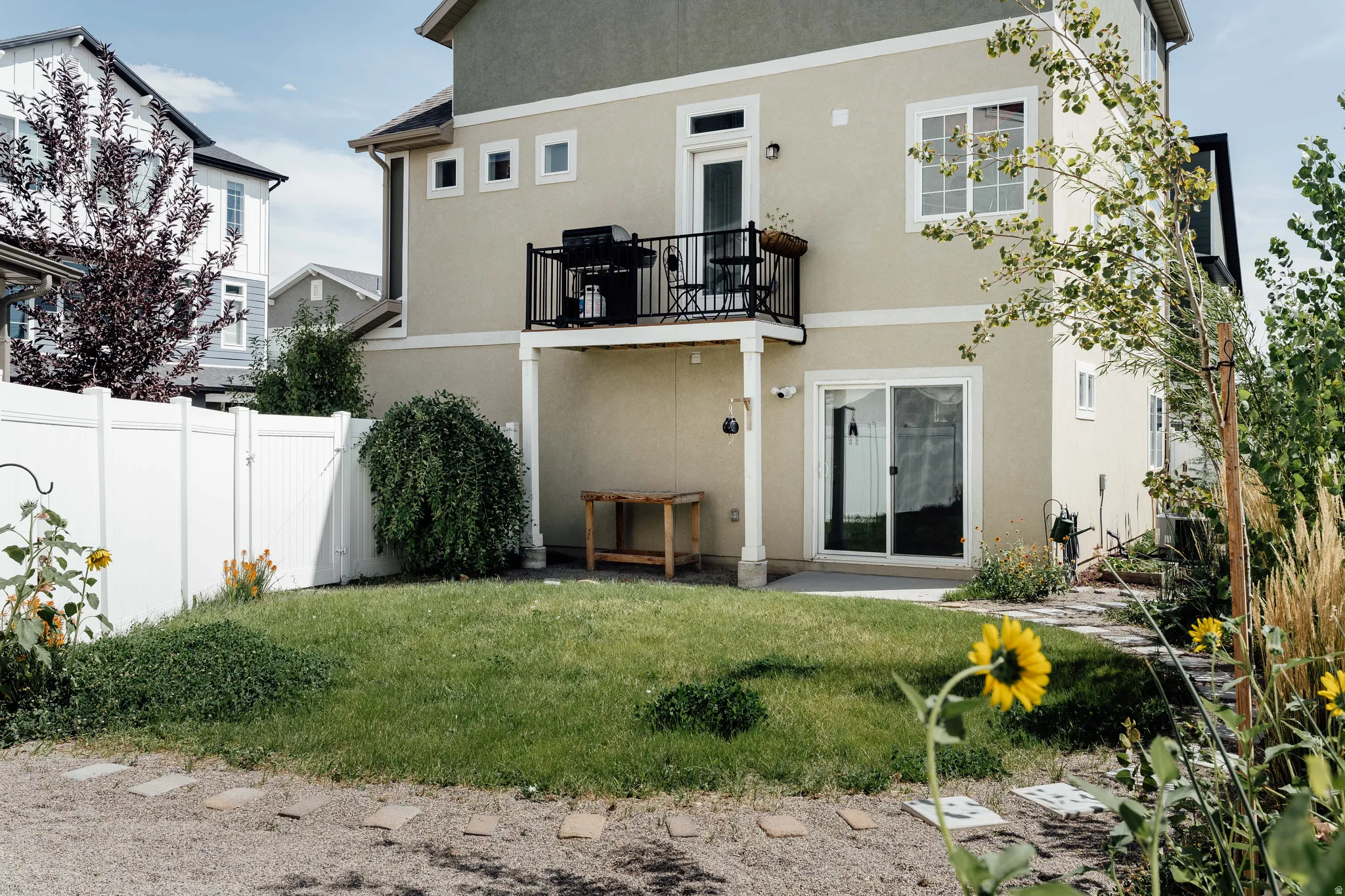 Rear exterior featuring a ground-level patio with sliding glass door access
