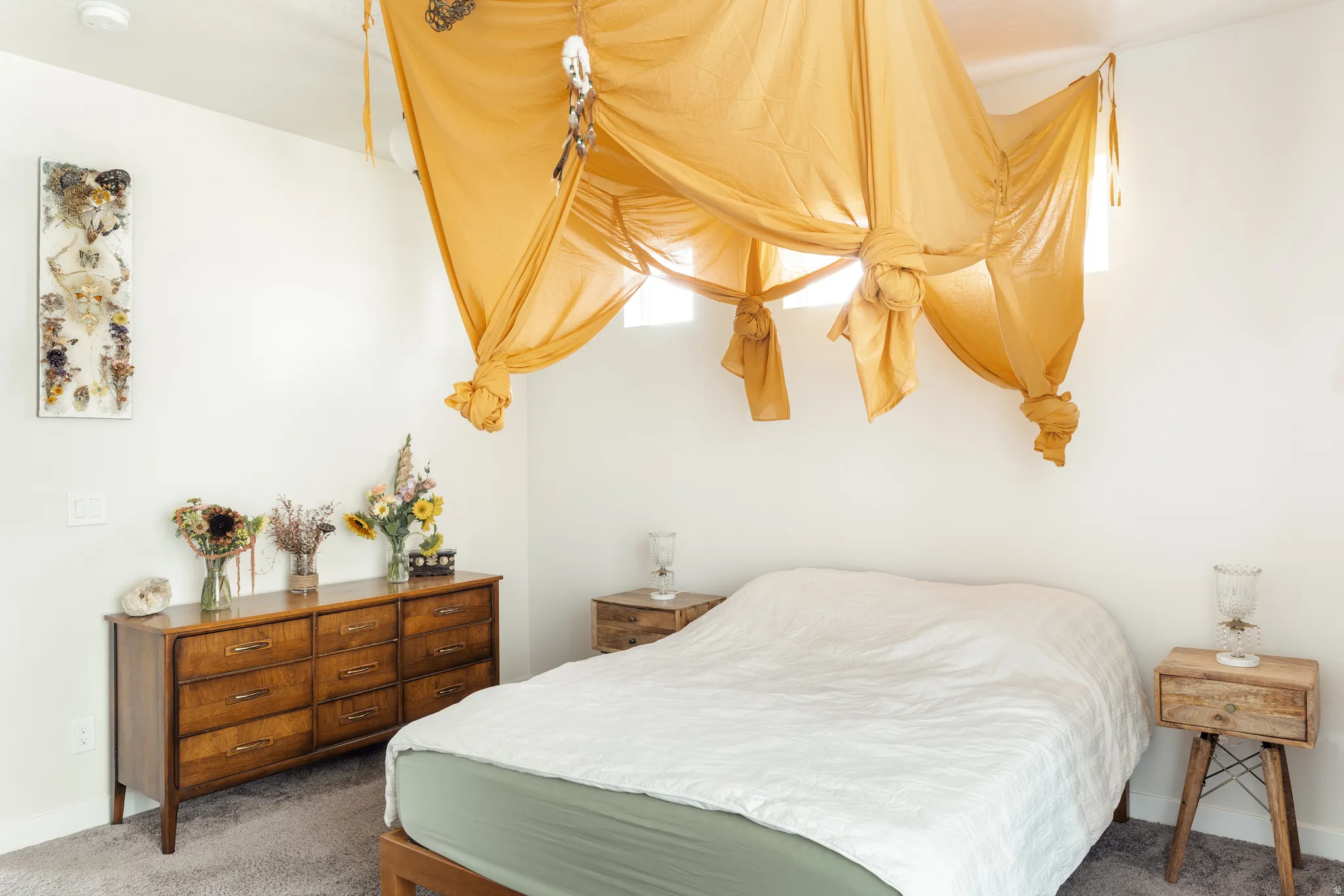 White walls and a gray carpeted floor provide a neutral backdrop