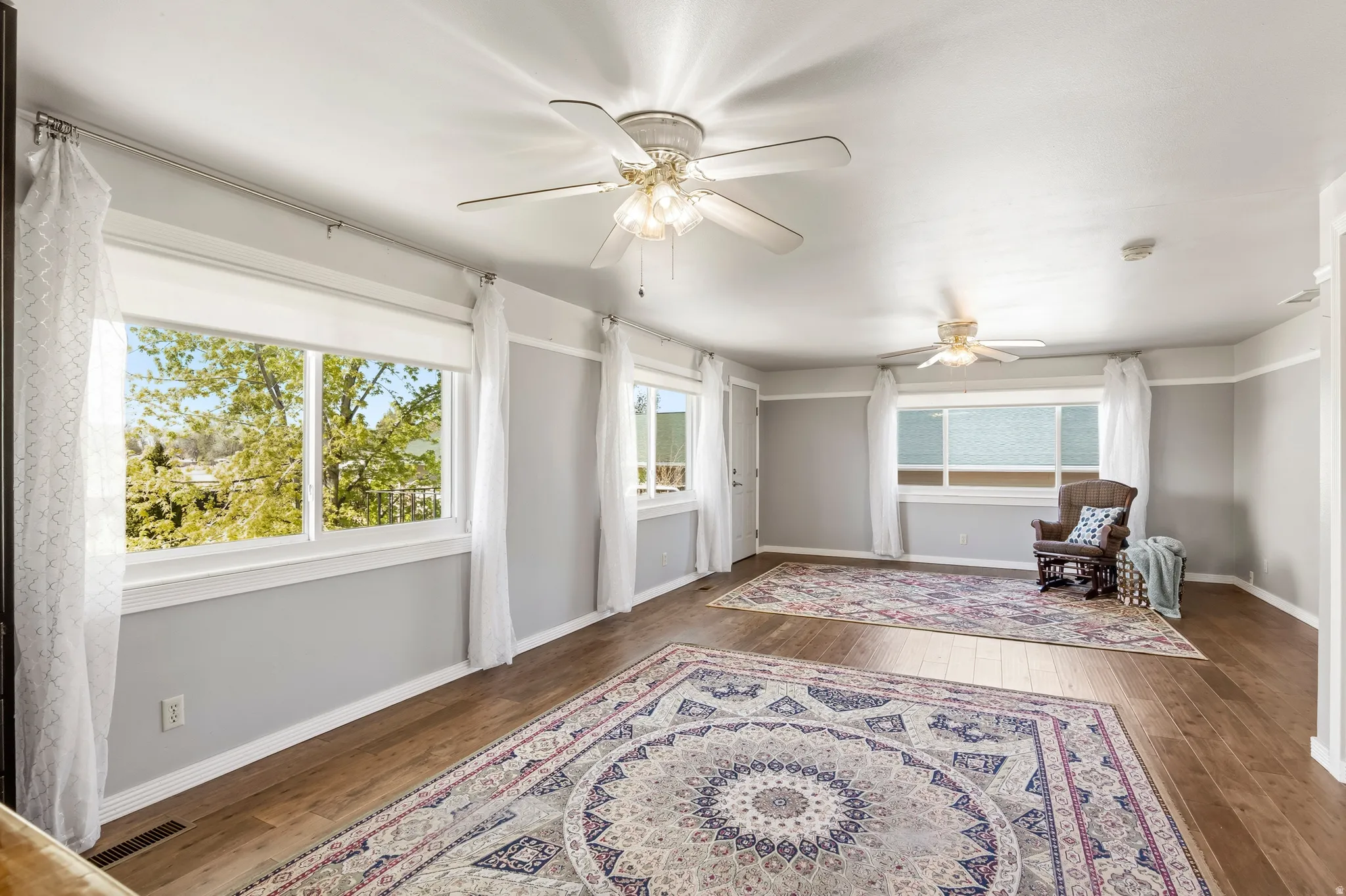Spacious interior with wood-finish flooring and light gray walls
