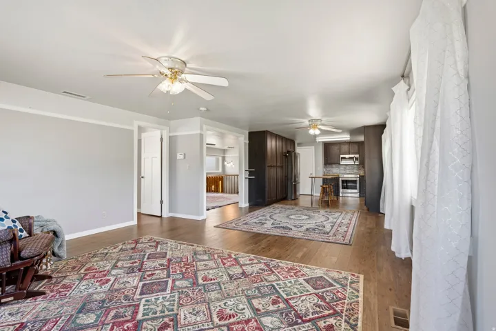 Open-concept living area featuring wood-finish flooring and light gray walls