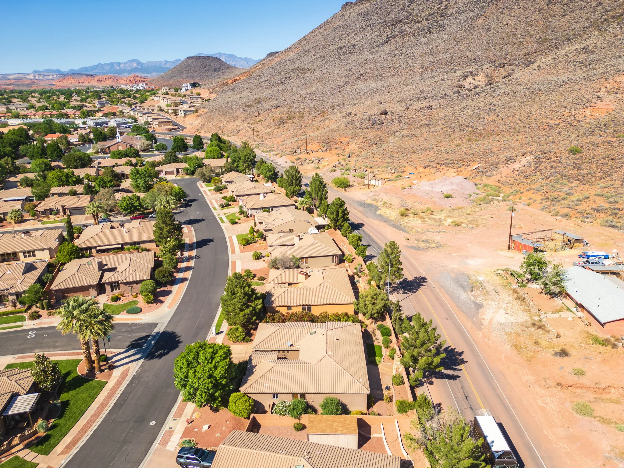 Residential community with uniform earth-toned roofing and landscaping