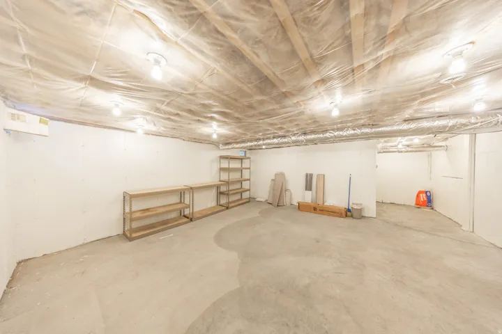 Large basement storage room under living room addition.