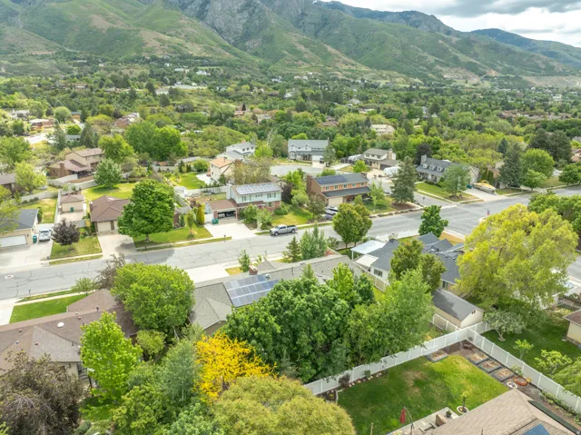 Expansive residential area featuring established homes, mature trees, and mountainous terrain