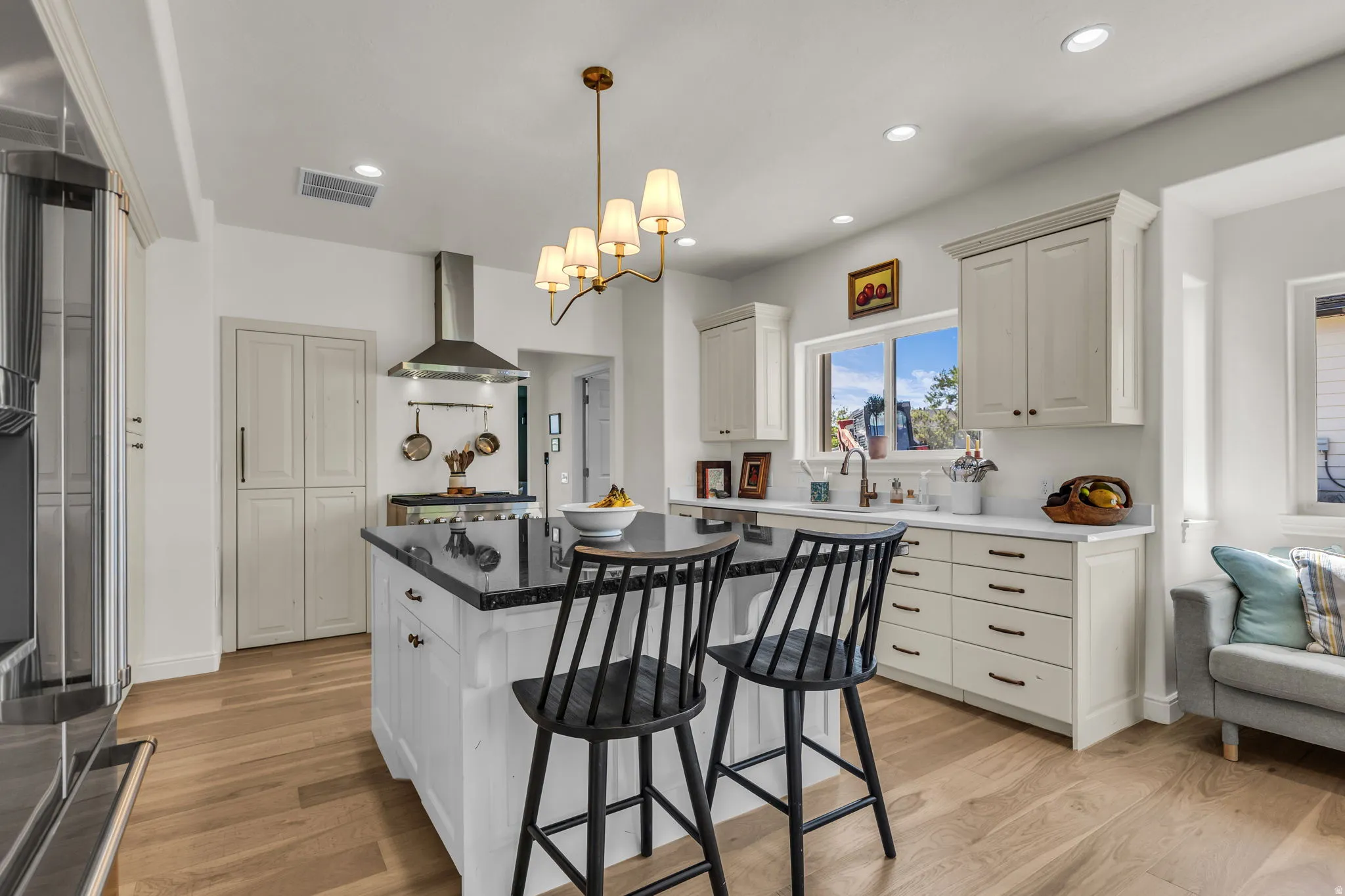 Spacious eat-in kitchen with granite and quartz, a hidden pantry, and a balcony to the backyard.