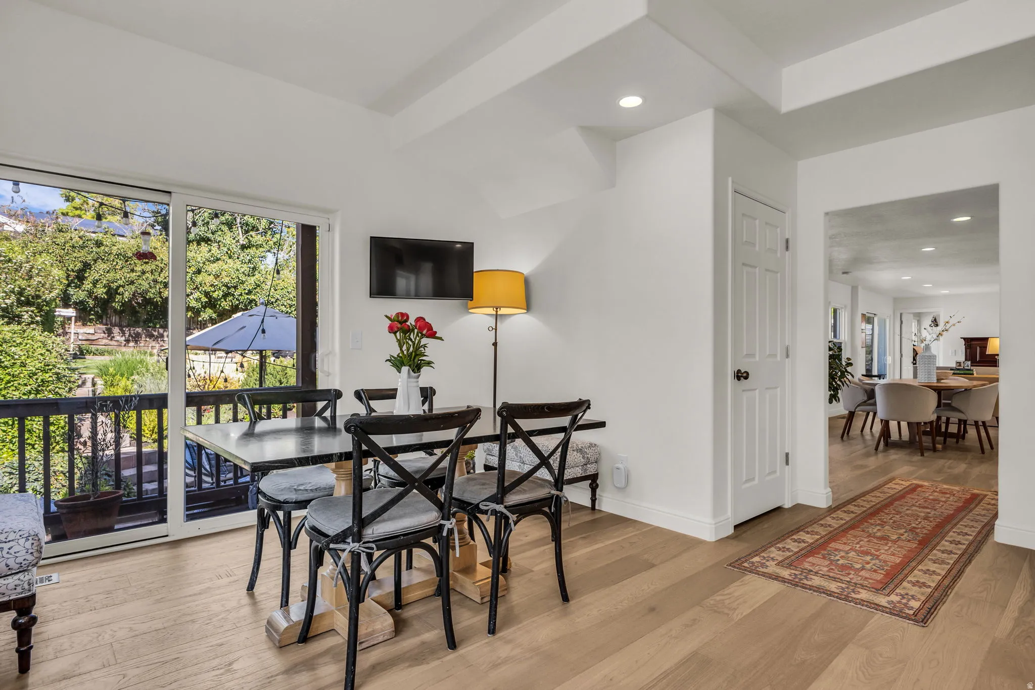 Spacious eat-in kitchen with granite and quartz, a hidden pantry, and a balcony to the backyard.