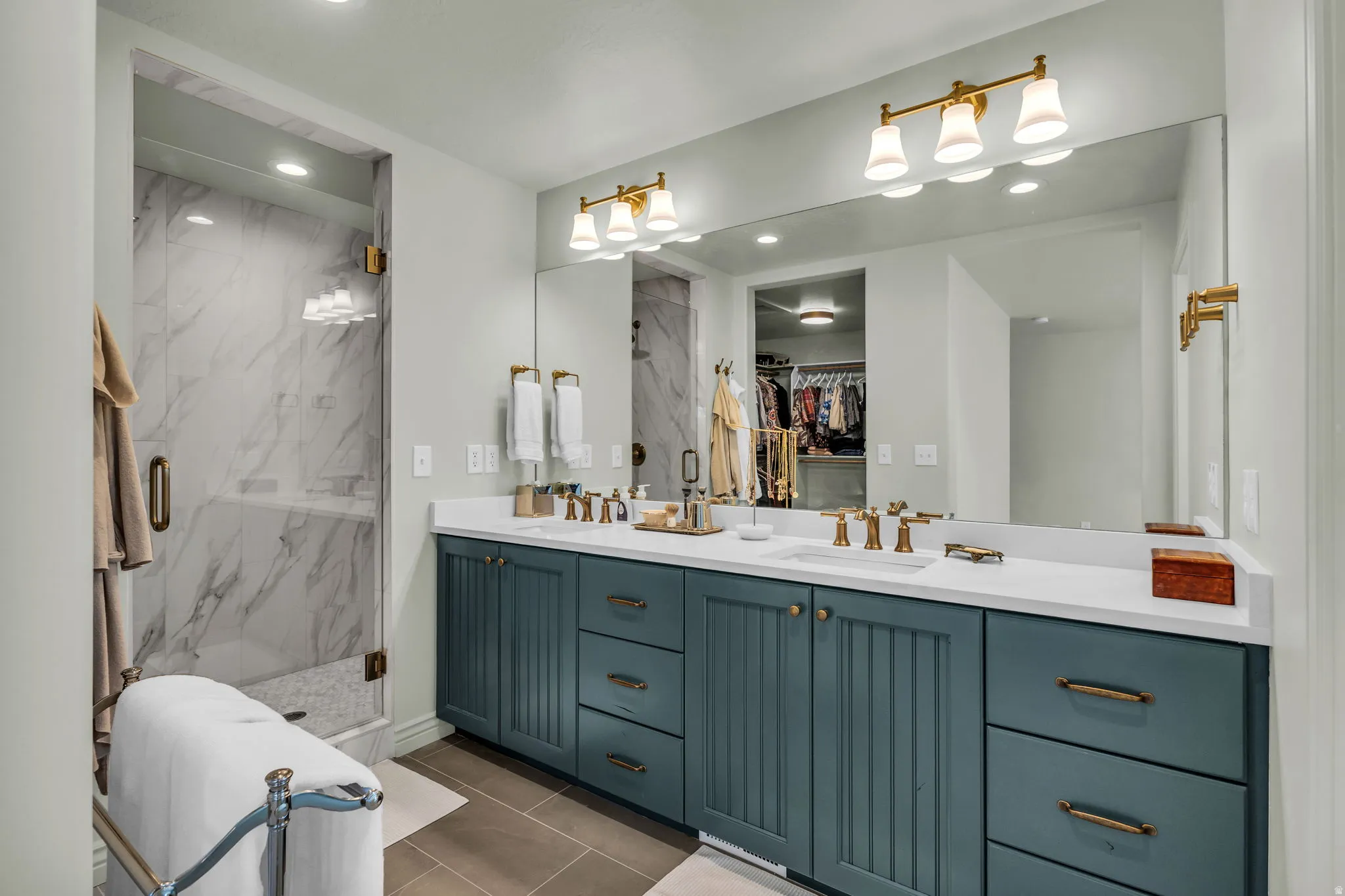 Spa-inspired primary bathroom that leads to a walk-in closet.